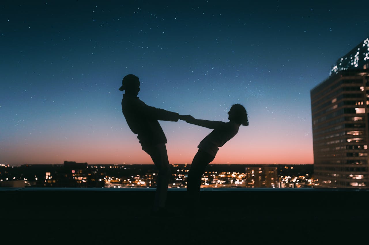 The Art of Drawing Readers In: Your attractive post title goes here A couple silhouetted against a starry sky on a rooftop in Minneapolis at sunset.